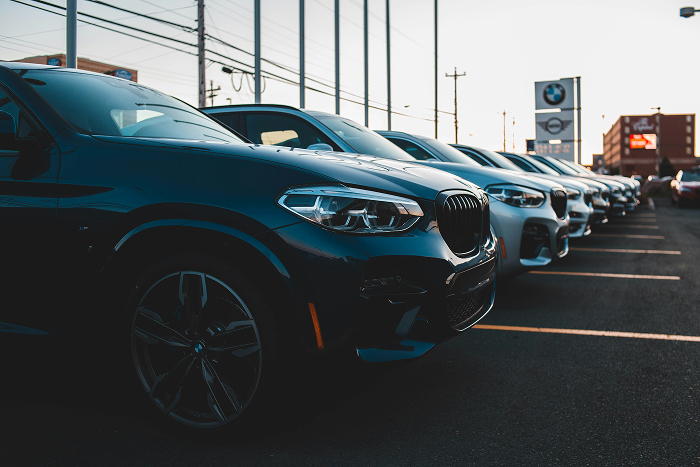Row of vehicles on a dealership lot, representing managed inventory accounting