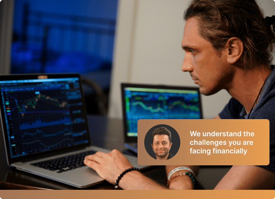 Day trader reviewing charts on multiple screens