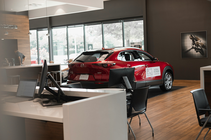 Car dealership showroom floor with sales desks